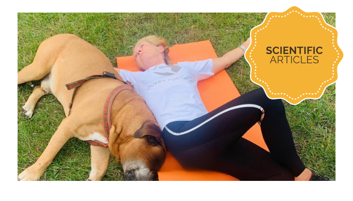 woman with a dog laying on the yoga mat 